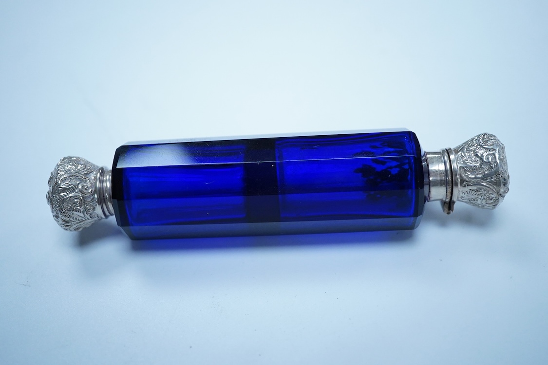 A late 19th century white metal mounted decagonal blue glass double ended scent bottle, 12.8cm.